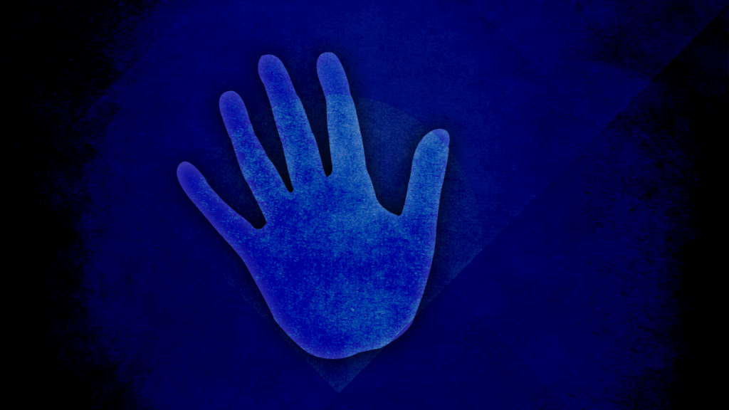 A hand reaching forward to prevent a negative action